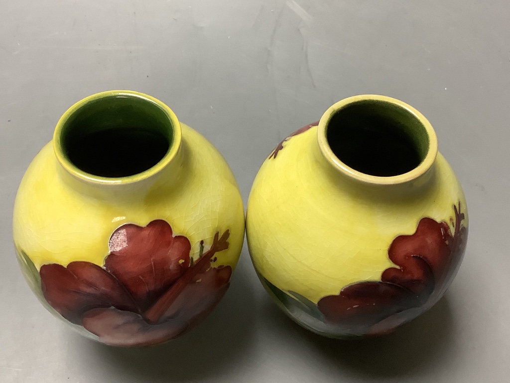 A pair of Moorcroft yelow ground Hibiscus vases, height 9cm